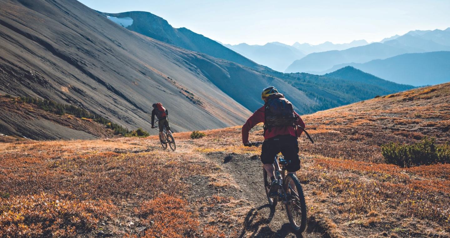 Two bikers ride through the Canadian mountains