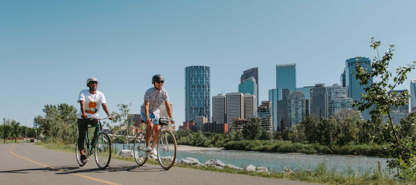 Two bikers alongside a river in Calgary