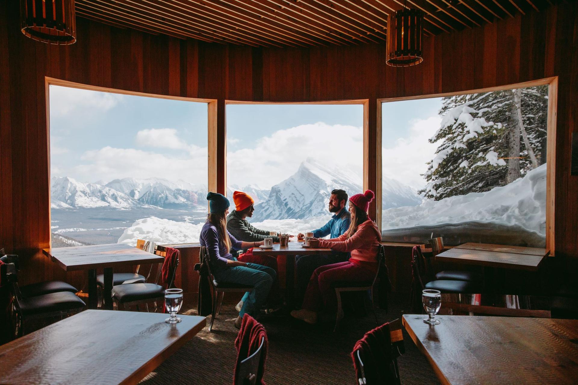 Four people share a table in a ski chalet