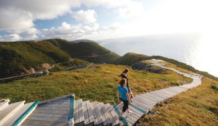 Two hikers descend the stairs on the Cabot Trail