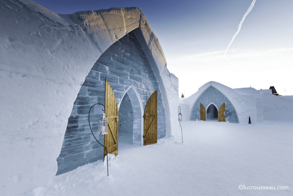 Gothic-arched doorways carved from ice and snow mark the dramatic entrance to Hôtel de Glace near Quebec City, Quebec.