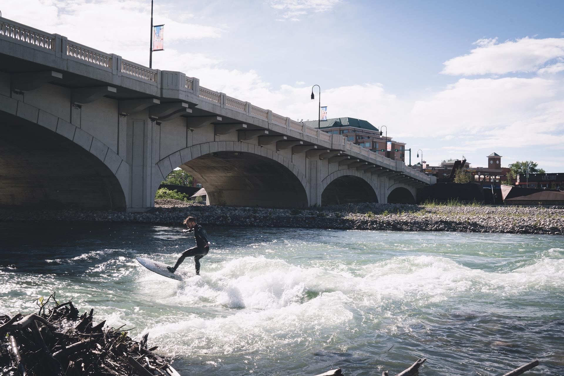 River surfing on the Bow River by the 10th Street bridge in Calgary