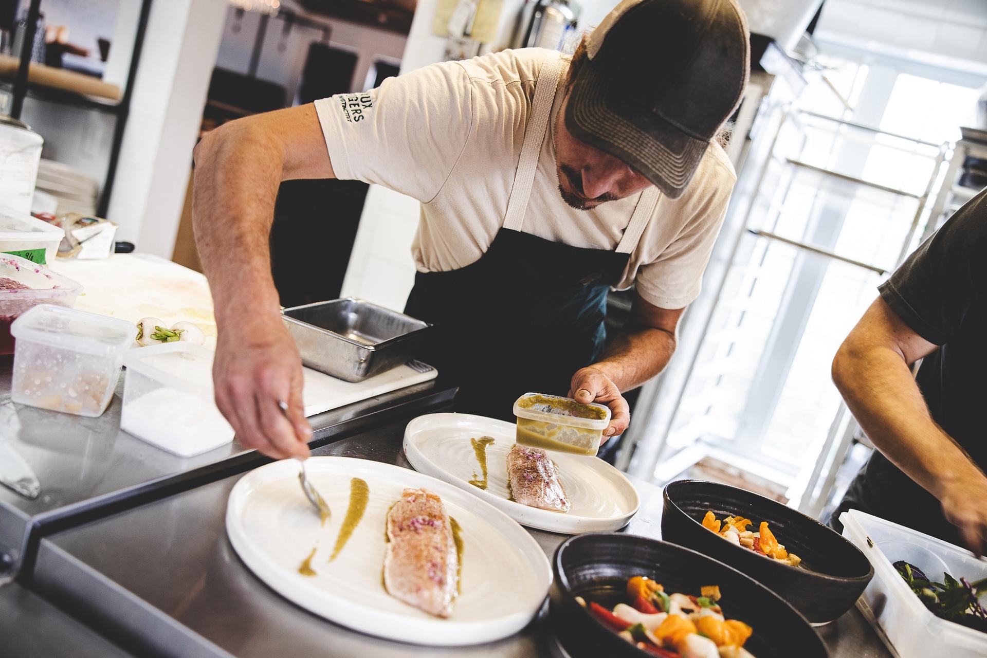 Staff at Faux Bergers plating fish