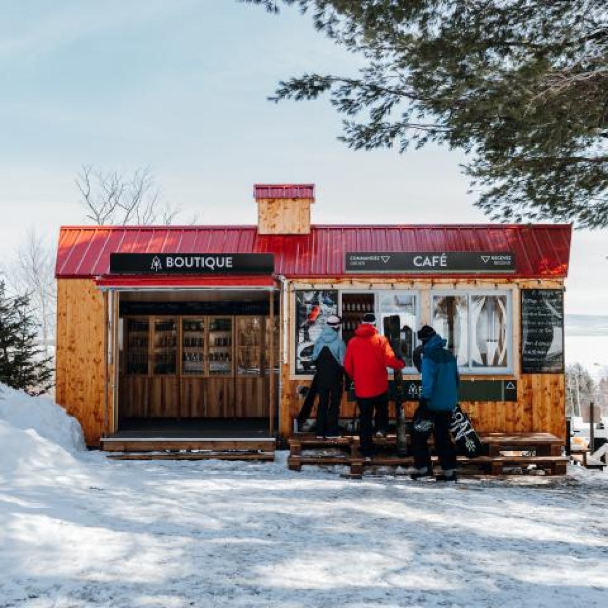 Skiers at an outdoor cafe at Le Massif ski resort