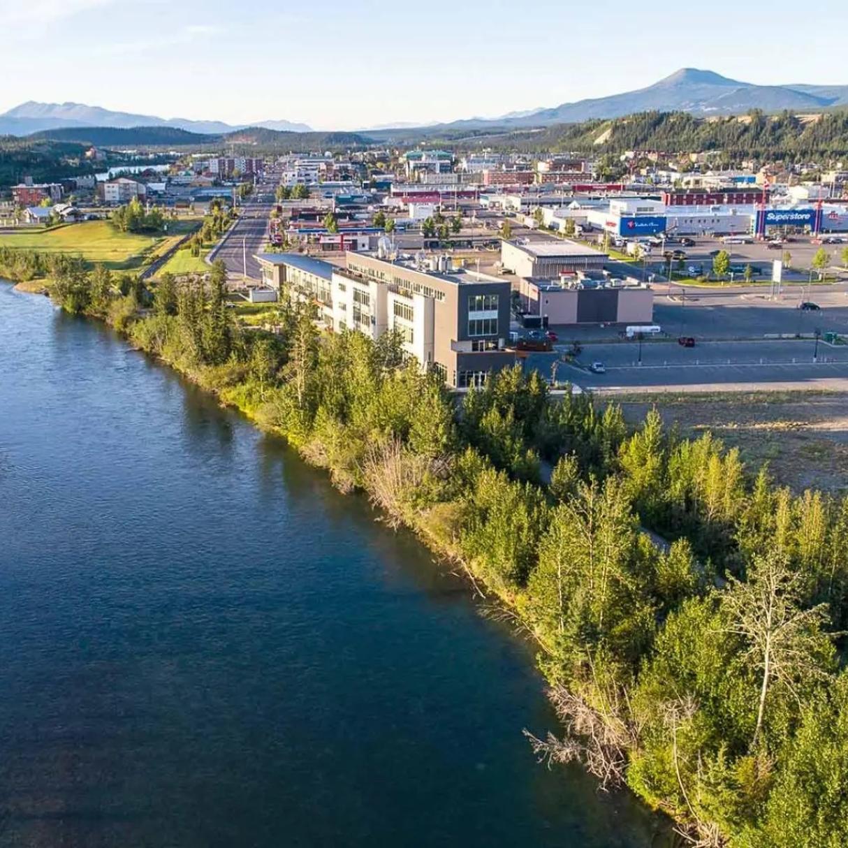 An aerial view of Whitehorse with the Yukon river running beside it